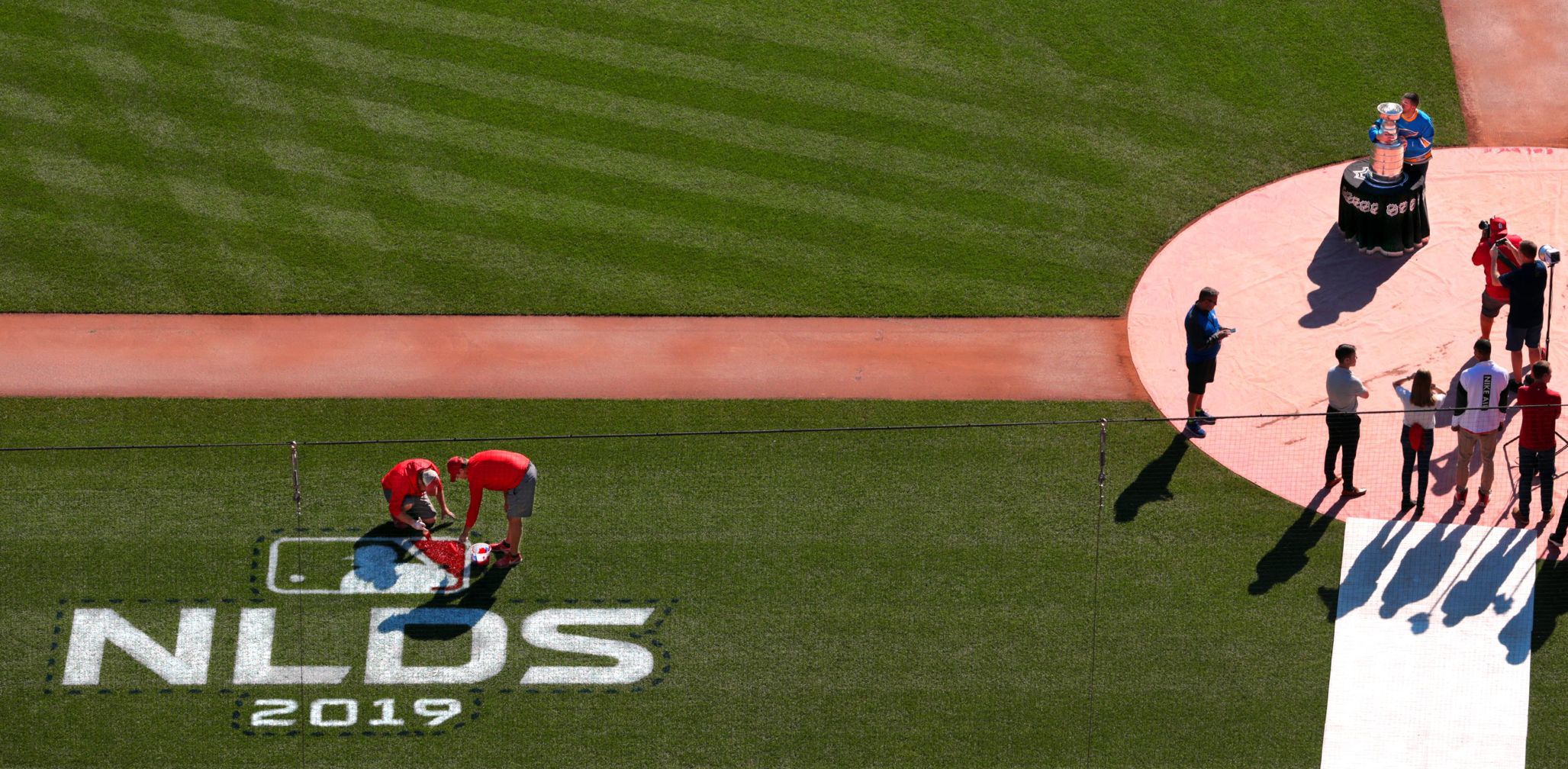 Big day at Busch Stadium as postseason logos painted while employees get the Cup
